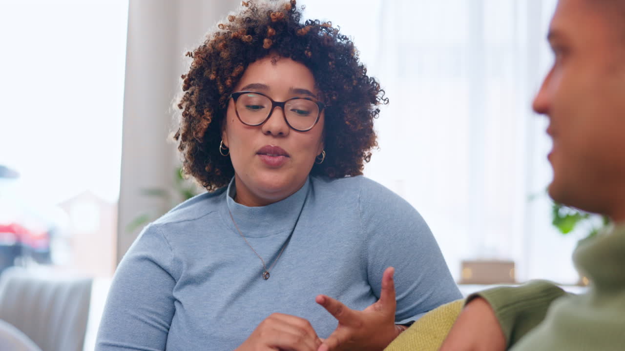 Love, talking and couple on a sofa