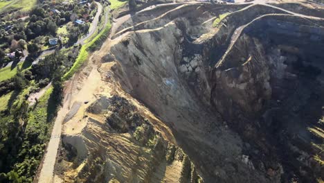 Aerial-tilt-down-to-huge-ground-slip-in-open-gold-mine-pit