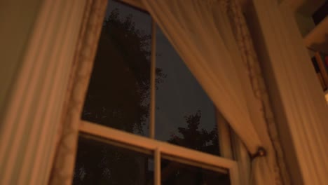 lightning outside a window at night.