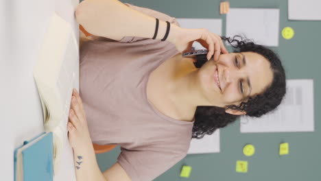 vertical video of female student getting good news on the phone.