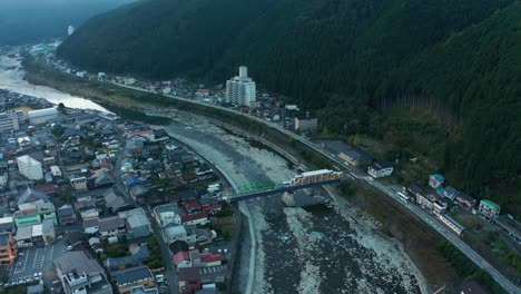 Aerial-View-of-Gero-Onsen-Ryokans-and-Hida-River,-Gifu-Japan