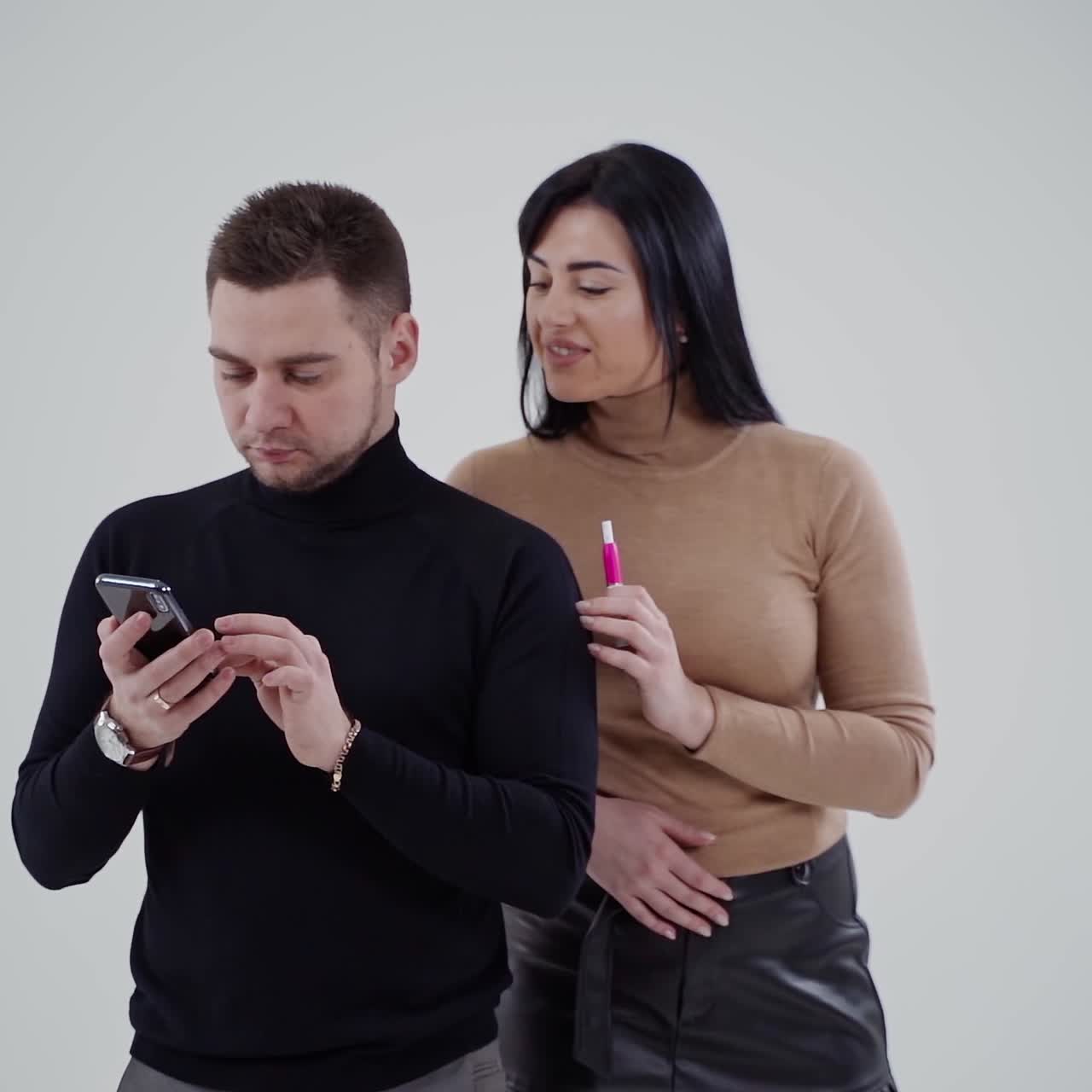 . Business people isolated on grey. Successful business couple standing in studio