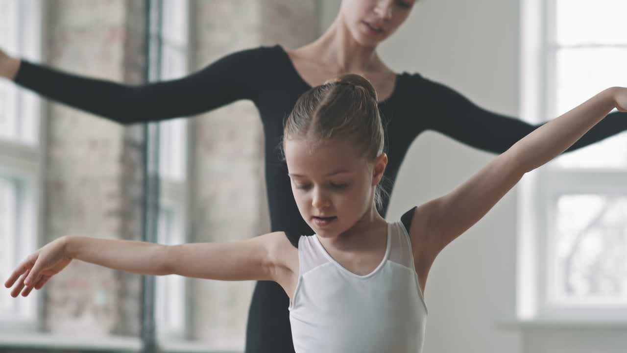 Adult And Small Ballerinas Dancing Synchronically