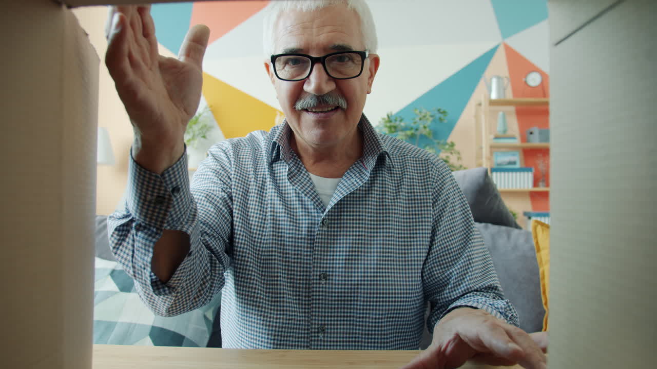 Senior Man Packing or Unpacking Boxes