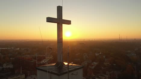 Drone-aerial-view-of-flying-birds-near-church-in-Kaunas,-Lithuania