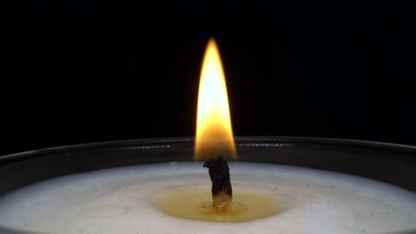 hand lighting a candle with a lighter. macro shot.