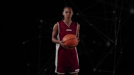 Animation-of-network-of-connections-over-female-basketball-player-on-black-background