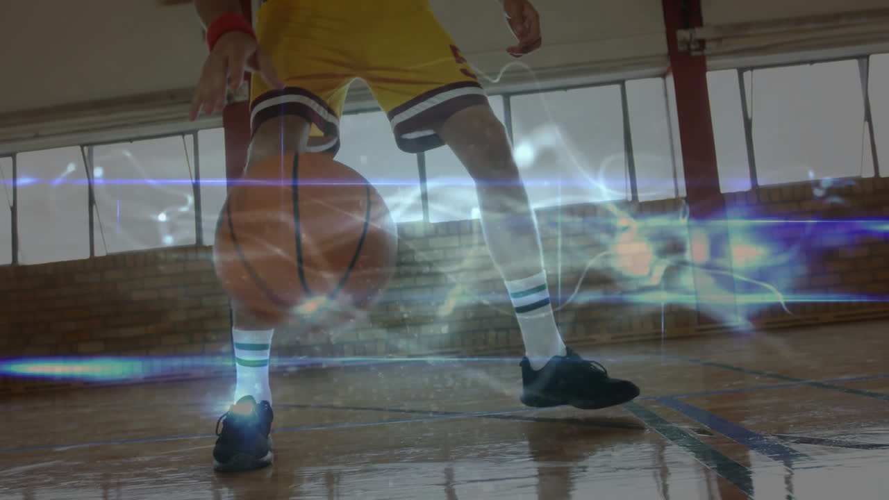 On school court, basketball player dribbling with glowing animation effects