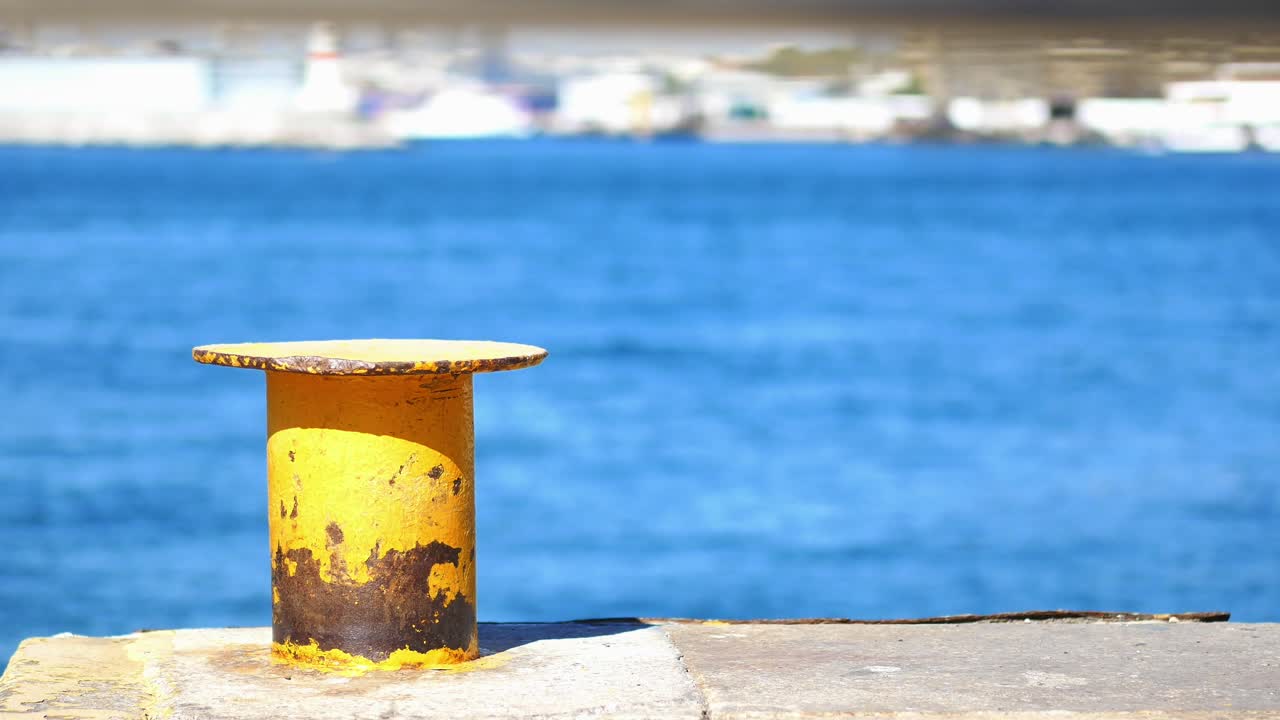 Yellow mooring bollard in a harbor