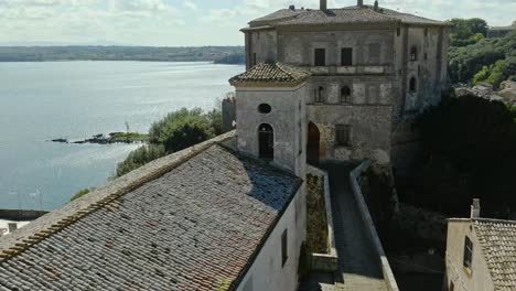 aerial around the rocca farnese castle and old town of capodimonte on lake bolsena, province of viterbo, italy