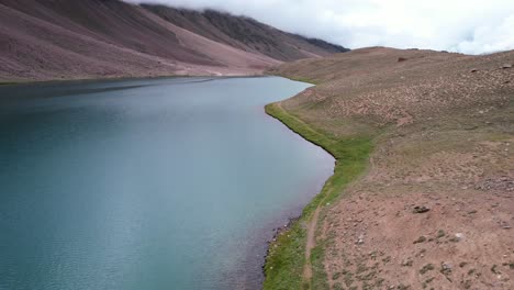 overhead aerial of chandra taal lake in the mountains of himachal pradesh india