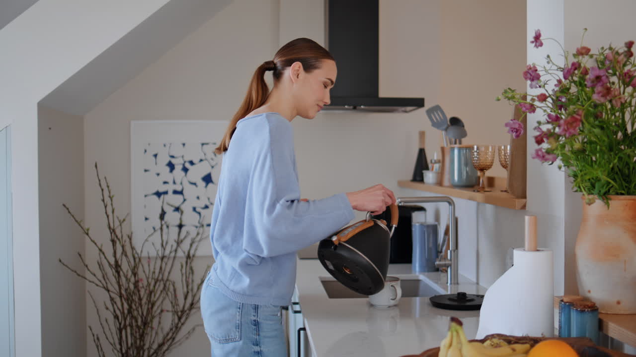 Young housewife preparing coffee drink enjoying aroma in luxury kitchen closeup