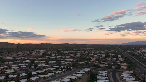 real estate homes in green valley near tucson arizona with pima mines in distance, drone forward