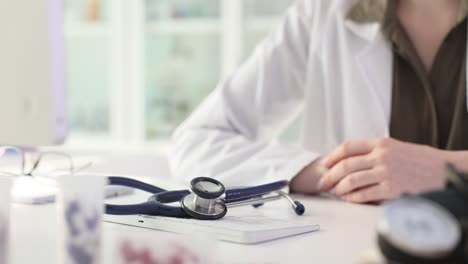 doctor's hands with a stethoscope in a medical office