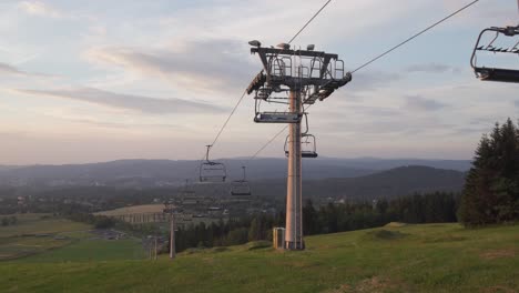 closed ski lift in the summer before sunset, panning left