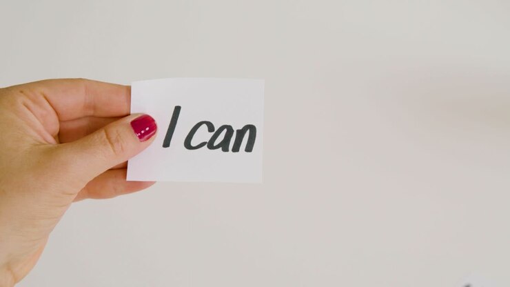 Woman hand cut letter t from I can't written text.