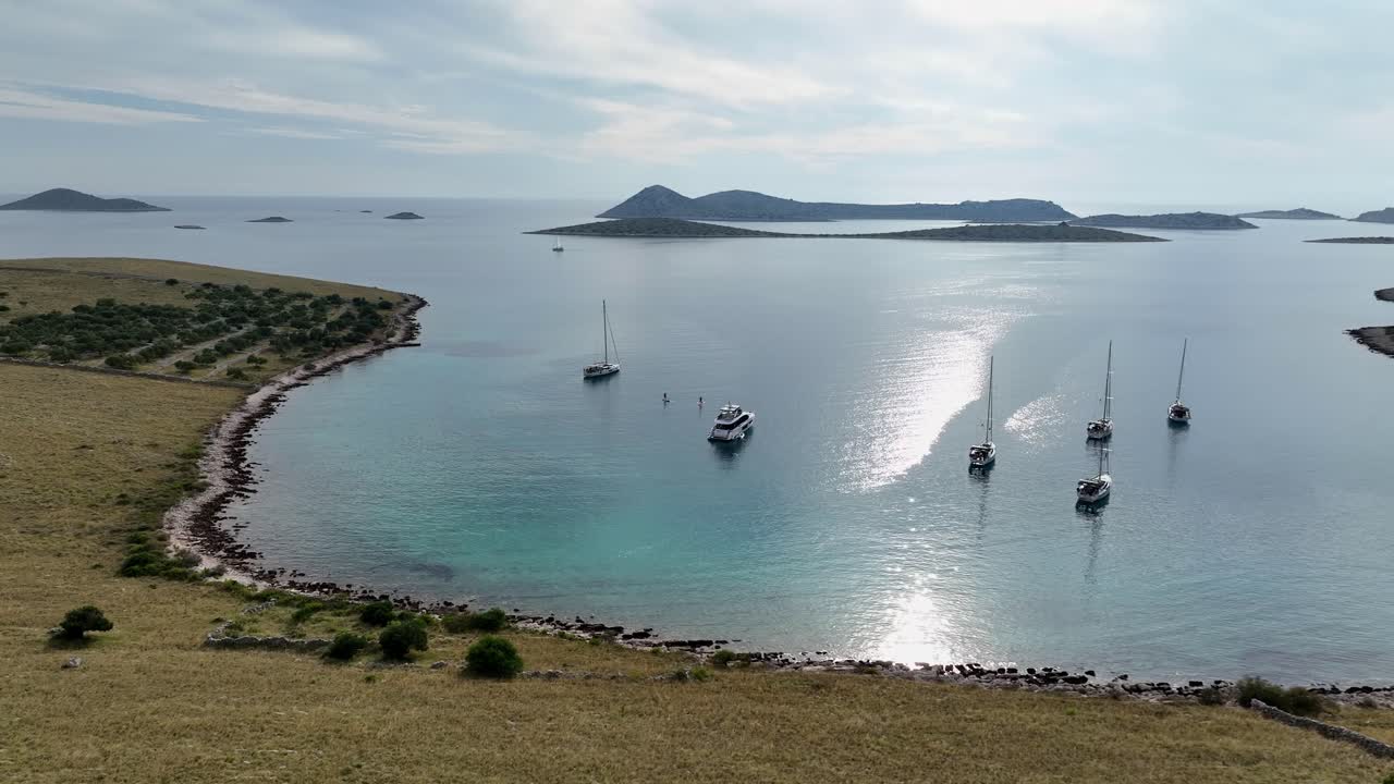 Boats sailing in clear blue water around kornati islands, croatia, aerial view