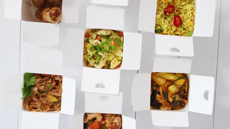 asian take away or delivery food concept  paper boxes placed on white wooden table