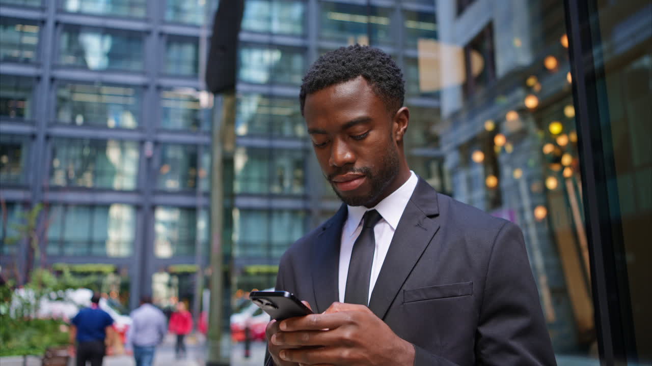 Young Businessman Wearing Suit Using Mobile Phone Outside Offices In The Financial District Of The City Of London UK Shot In Real Time 1