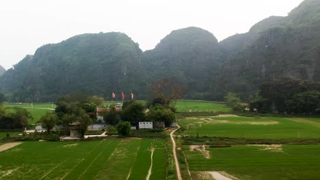 Aerial-ascend-over-Thai-Vi-Temple-in-Vietnamese-Countryside-Tam-Coc,-Ninh-Binh,-Vietnam