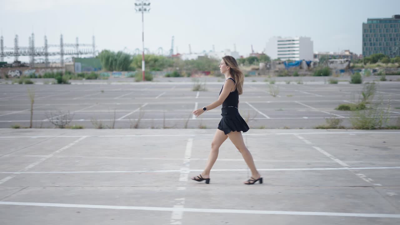 Woman Walking in an Urban Parking Lot