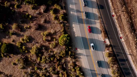 aerial view of cars driving on a highway through a dry landscape