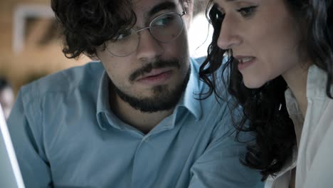 Closeup-shot-of-focused-young-woman-talking-with-confident-colleague