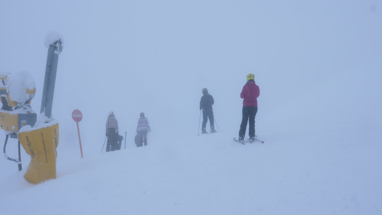 Skiers in foggy winter landscape