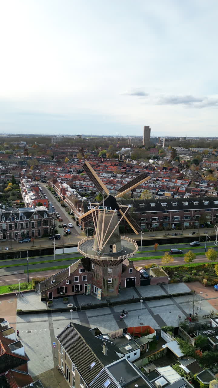 Aerial drone view of the Molen De Roos, historic windmill in Delft, Netherlands. Vertical