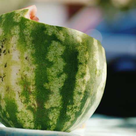 the notched watermelon lies on the table in the country house