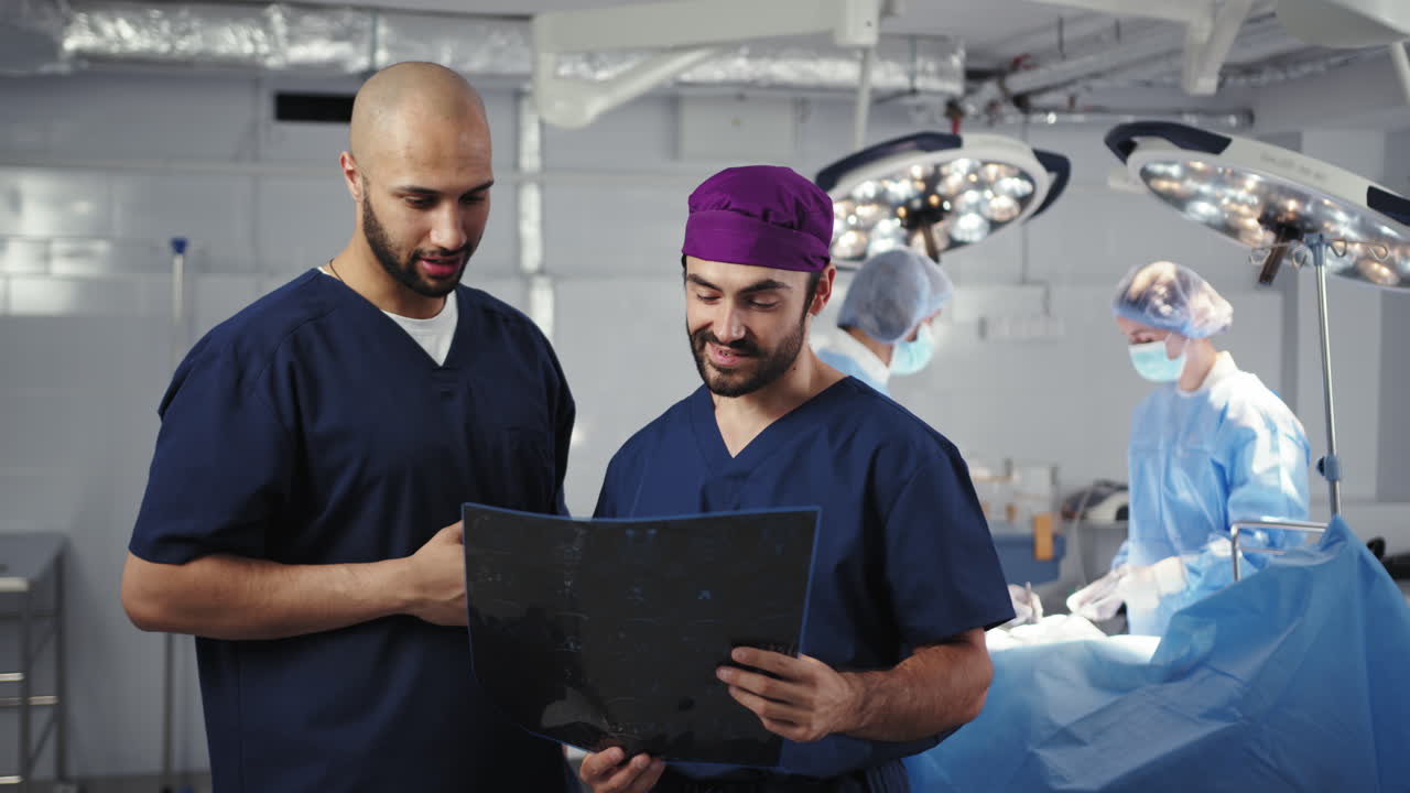 Surgeons examining xray in or