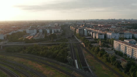 Panorama-curve-shot-of-large-city.-Urban-neighbourhoods-and-railway-junction-in-morning.-Fernsehturm-TV-tower-in-distance.-Berlin,-Germany