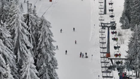 people skiing and riding chairlifts at a snowy winter ski resort