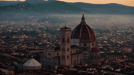 ascending pan down over florence duomo with morning mist and golden sunrise