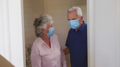 senior caucasian couple wearing face masks