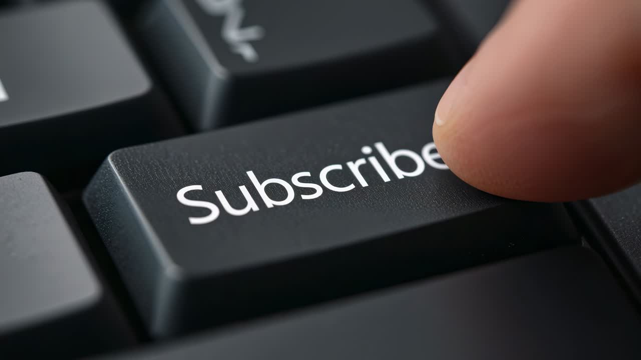 Pressing human fingertip engaging black Subscribe key on desk keyboard, confirming subscription