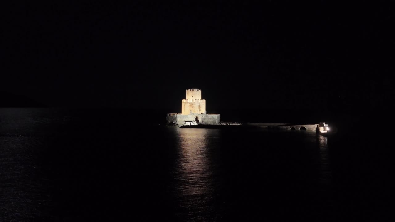 Methoni,Messenia,Peloponnese,Aerial view forward towards beautifully illuminated Bourtzi tower at night