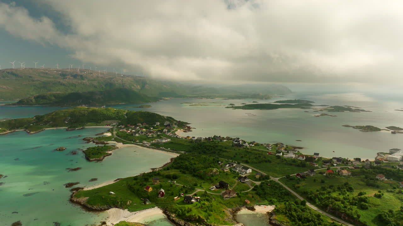 Aerial drone view of Sommarøy island in Northern Norway. Features white sandy beaches, clear turquoise water, and green landscapes. A scenic summer Arctic paradise in Troms