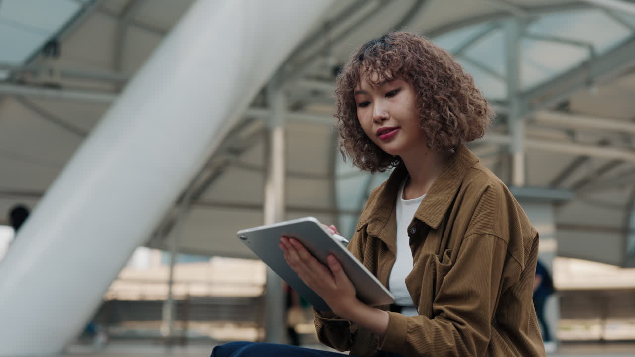Woman Using Tablet in Urban Setting