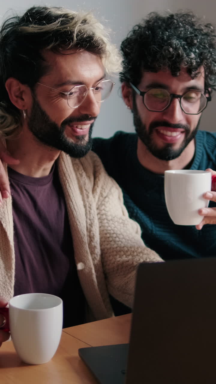 Gay Couple Working From Home on Laptop