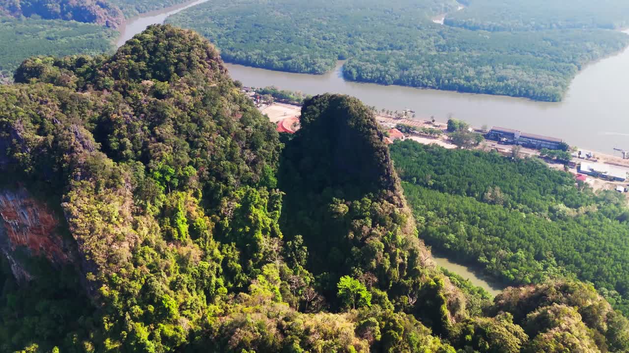 Aerial Ao Phang Nga National Park, Southern Thailand drone fly close to limestone rock mountains formation above mangrove forest jungle wild nature