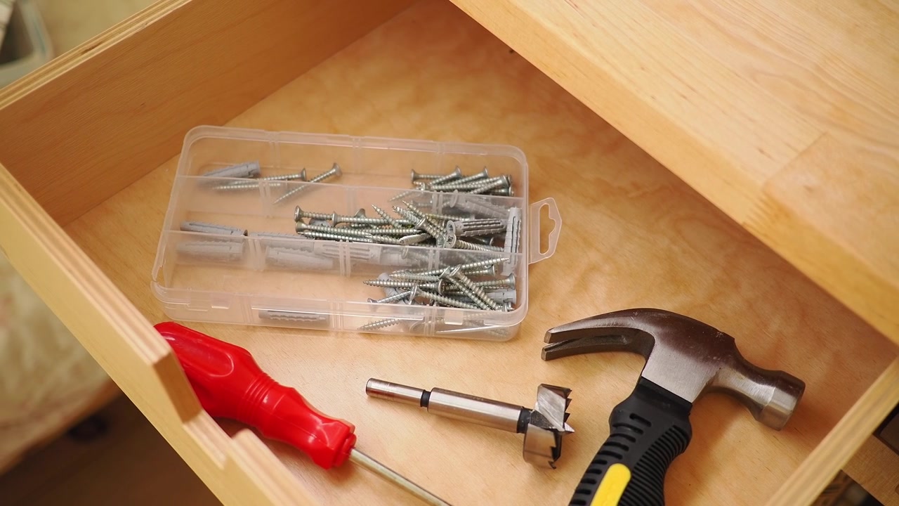 Assorted Hand Tools and Hardware Inside an Open Wooden Drawer