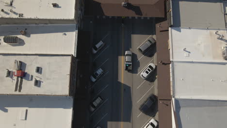 aerial view of a city street with parked cars