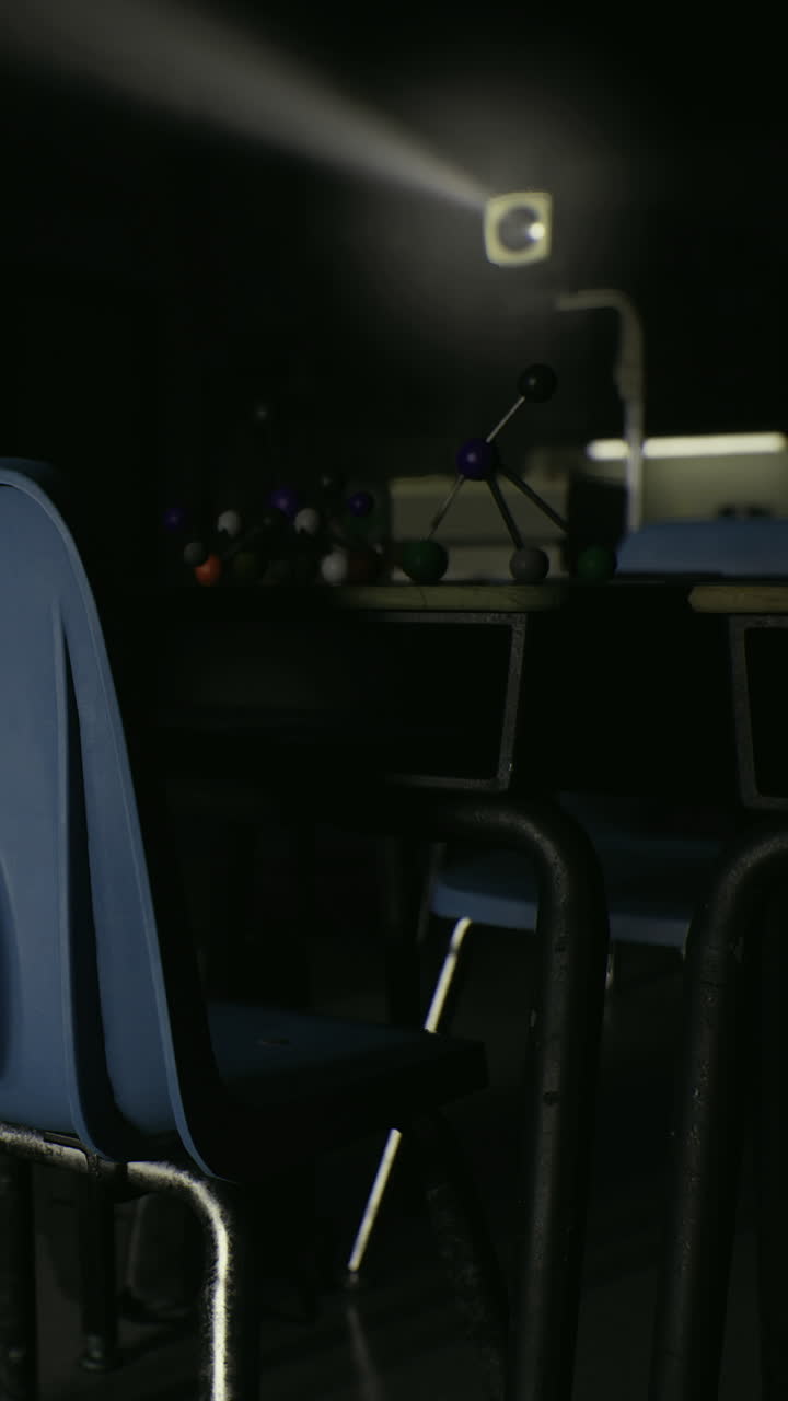 Tables and chairs in a dimly lit classroom with science equipment present