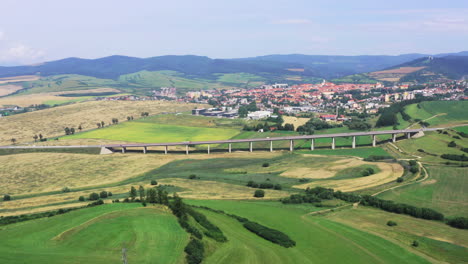aerial view of a bridge leading to a city in a rural landscape