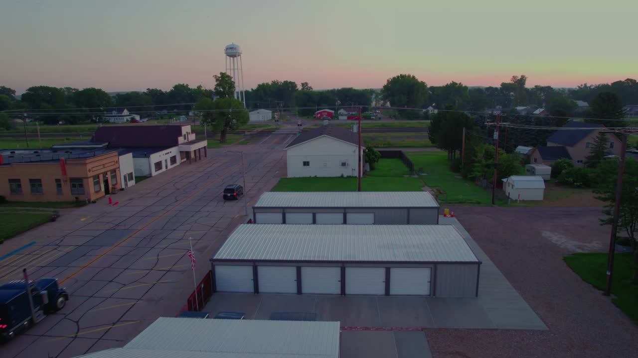 Aerial Shot of Livestock Truck Driving Through Small Town Maxwell Nebraska at Sunrise