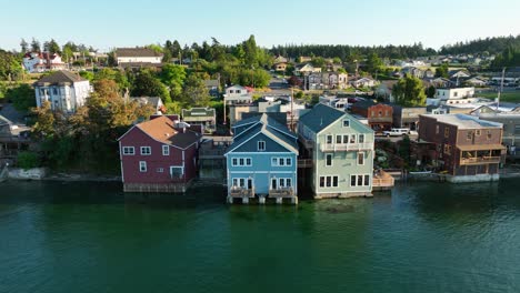 panning aerial shot of coupeville's historic business district with multiple buildings hanging out over the water