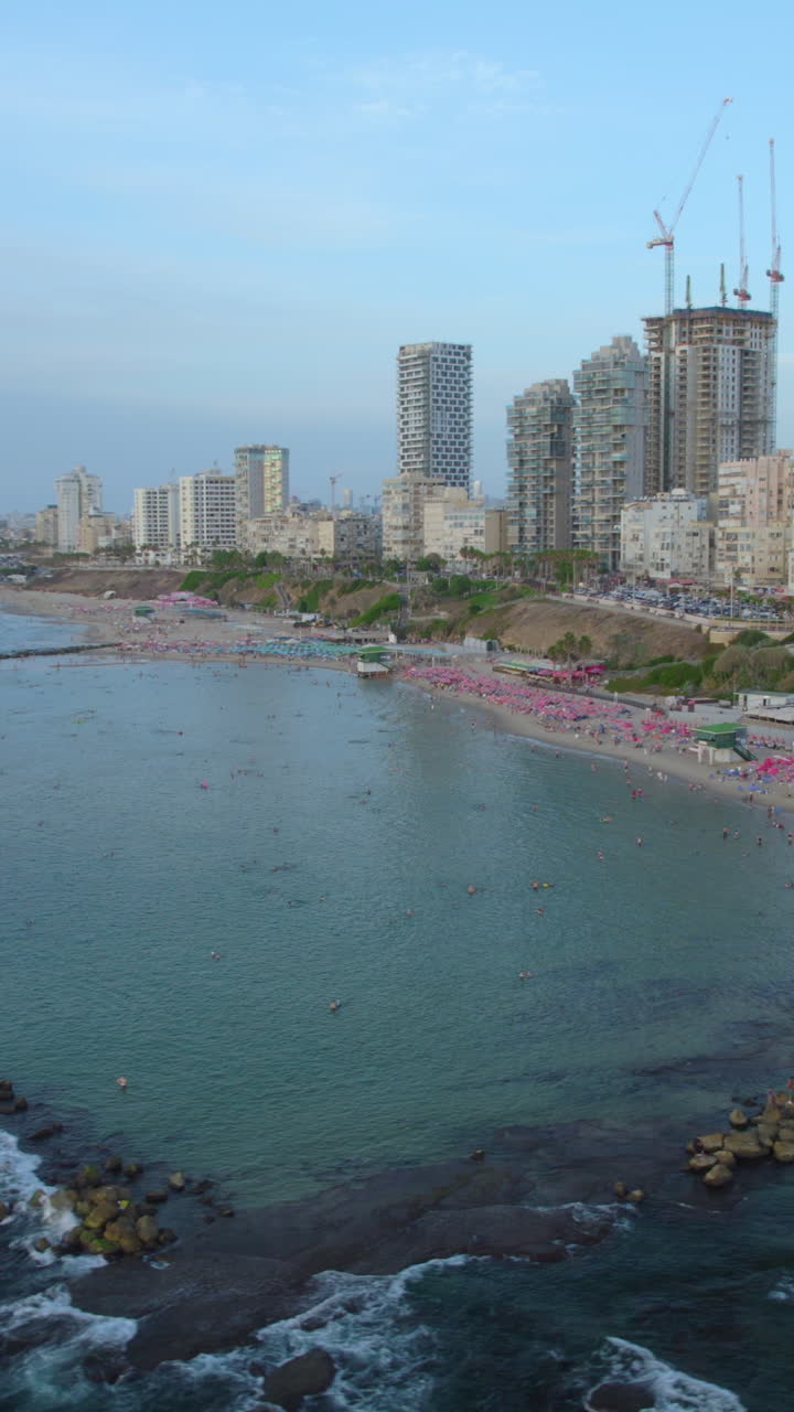 Bat Yam Hasela Beach lagoon – vertical video – calm shallow waters behind wave breakers, popular with families
