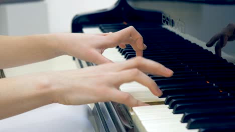 the close-up of the musician hands playing the piano. no face. 4k.