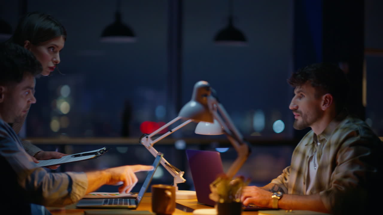 Woman assistant helping developer showing papers at night open space closeup